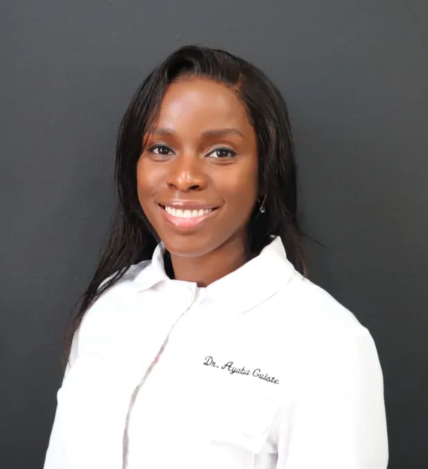 Dr. Ayaba Guiste, smiling, in her white clinic coat