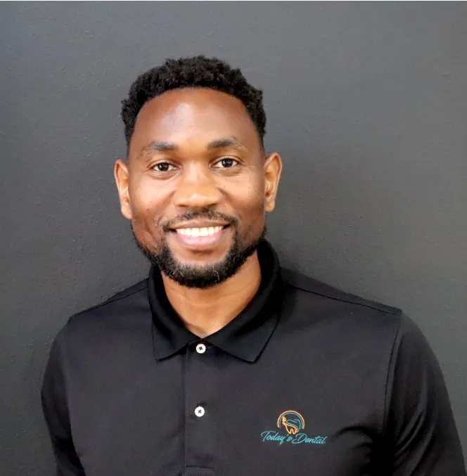 Elihu Guiste, smiling, in a black practice shirt