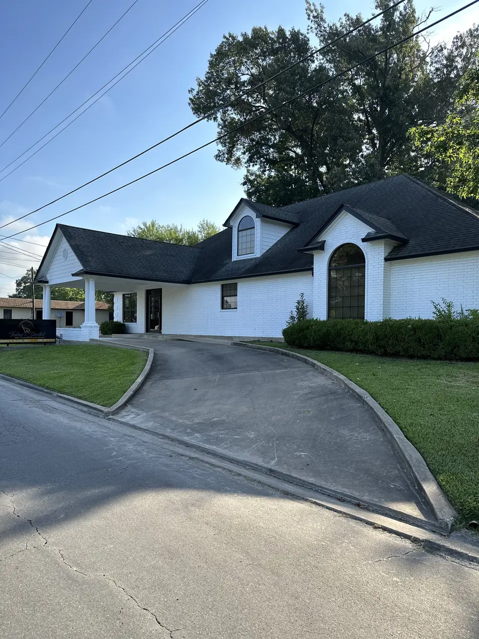 The side of the Today's Dental office with its arched window and curved driveway